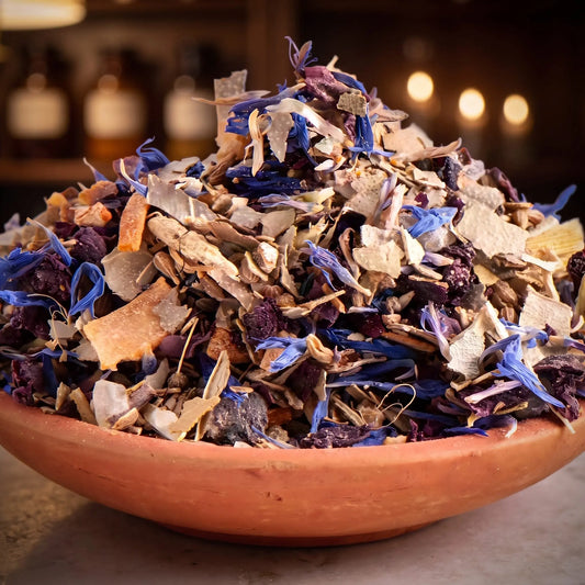 Klarträume, Räuchermischung der Reihe Kraftvoll Räuchern von Berk, 60 ml im Bügelglas: Nahaufnahme der Terracottaschale mit blauen Kornblumen und hellen Holzspänen vor der warmen, unscharfen Abendapotheke – Spirit of Gaia