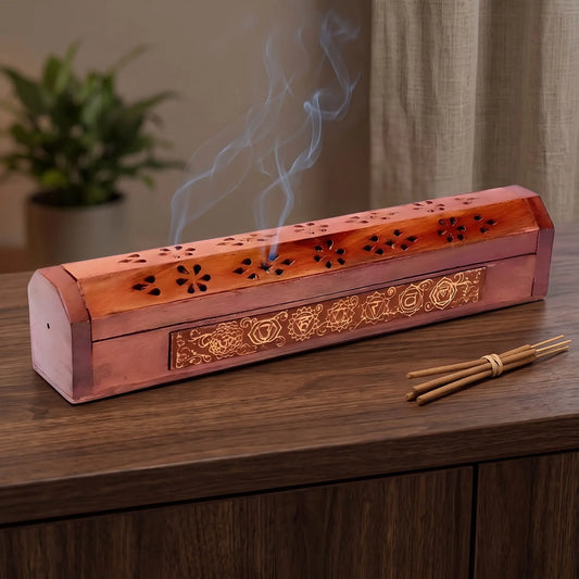 Kistchen/Halter Räucherstäbchen 7 Chakren in Benutzung mit feinem Rauch auf einem dunklen Holz-Sideboard am Abend