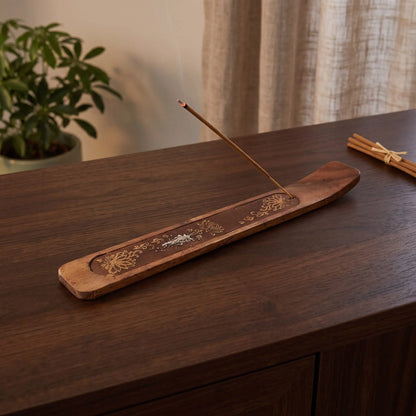 Räucherstäbchenhalter Lotus in Benutzung mit feinem Rauch auf einem dunklen Holz-Sideboard am Abend