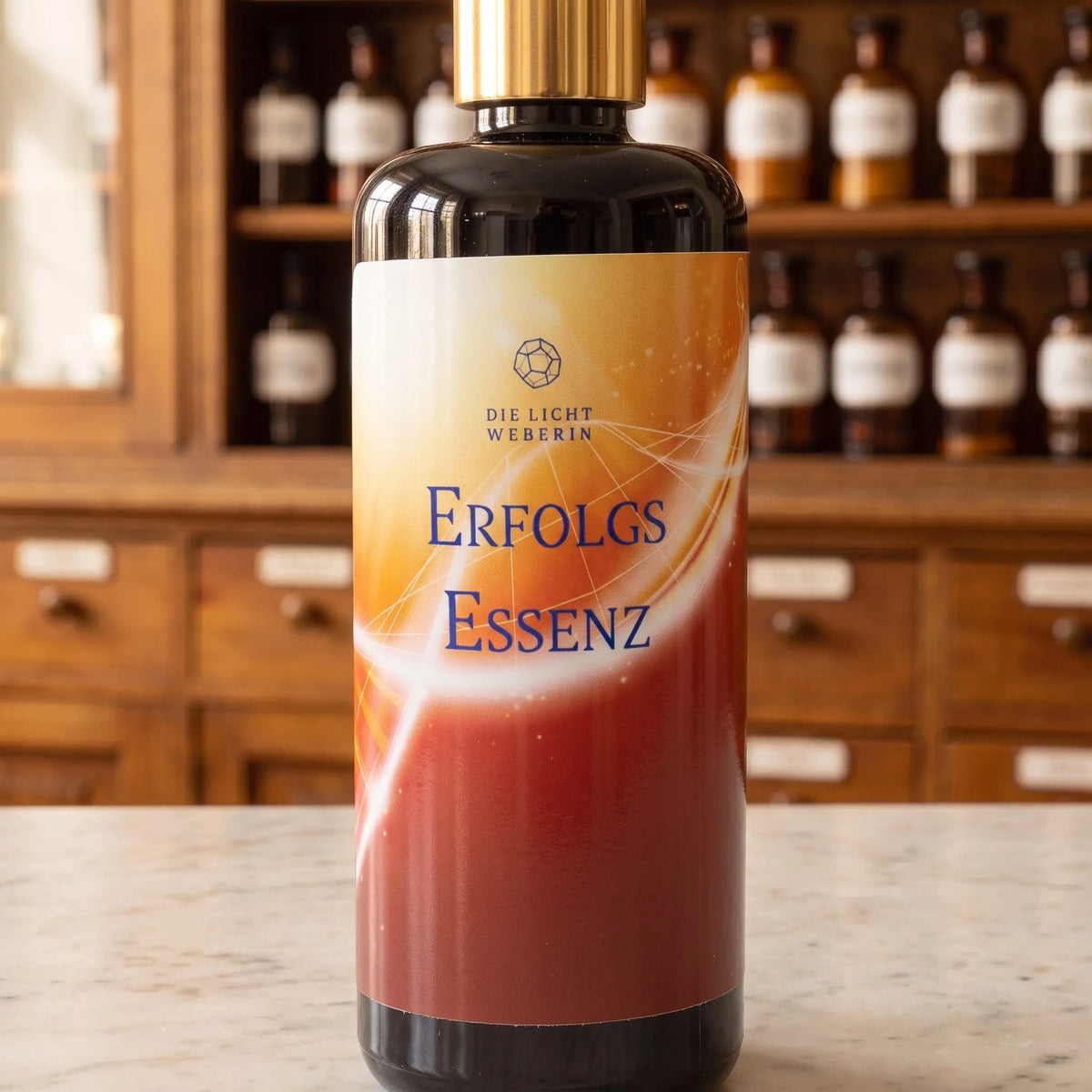 Etikett des Aura Sprays Erfolg aus der Nähe: Dodekaeder-Zeichen, Schriftzug Die Lichtweberin, orangeroter Farbverlauf