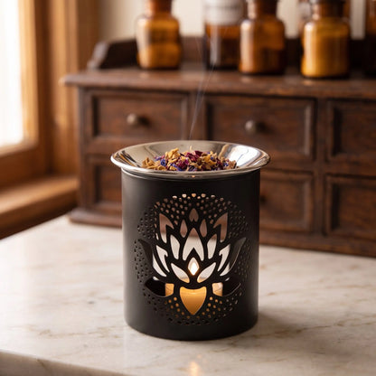 Schwarzes Räuchergefäß aus Eisen mit ausgestanztem Lotus und flacher Edelstahlschale – in der Anwendung