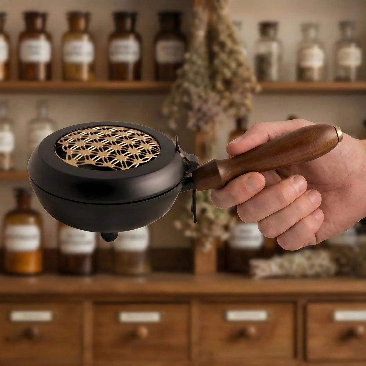 Hand hält das Räuchergefäß am Holzgriff, die Schale misst 11,5 Zentimeter im Durchmesser