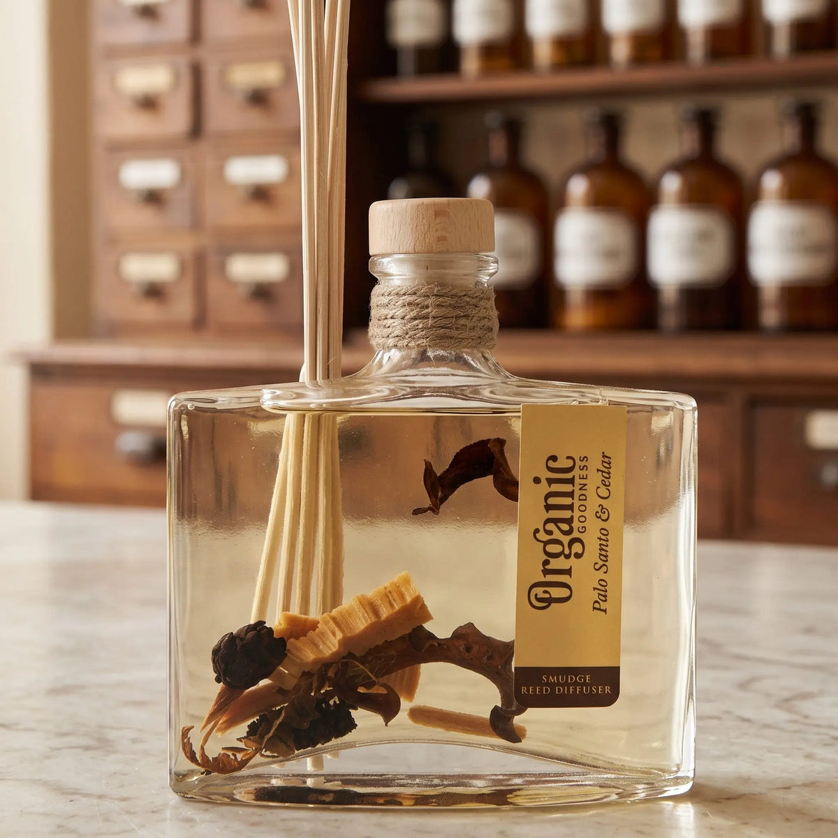 Flaschenhals des Reed Diffusers Palo Santo und Zeder aus der Nähe: Holzstopfen, Jutekordel, Schilfrohrstäbchen und die Hölzer im Öl