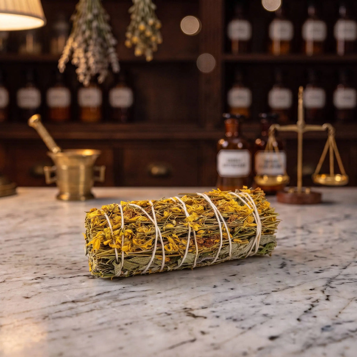 Premium-Räucherbündel Ausräuchern von Berk liegt auf der Marmortheke einer Apotheke am Abend, Beifuß, Salbei und Johanniskraut mit hellem Garn