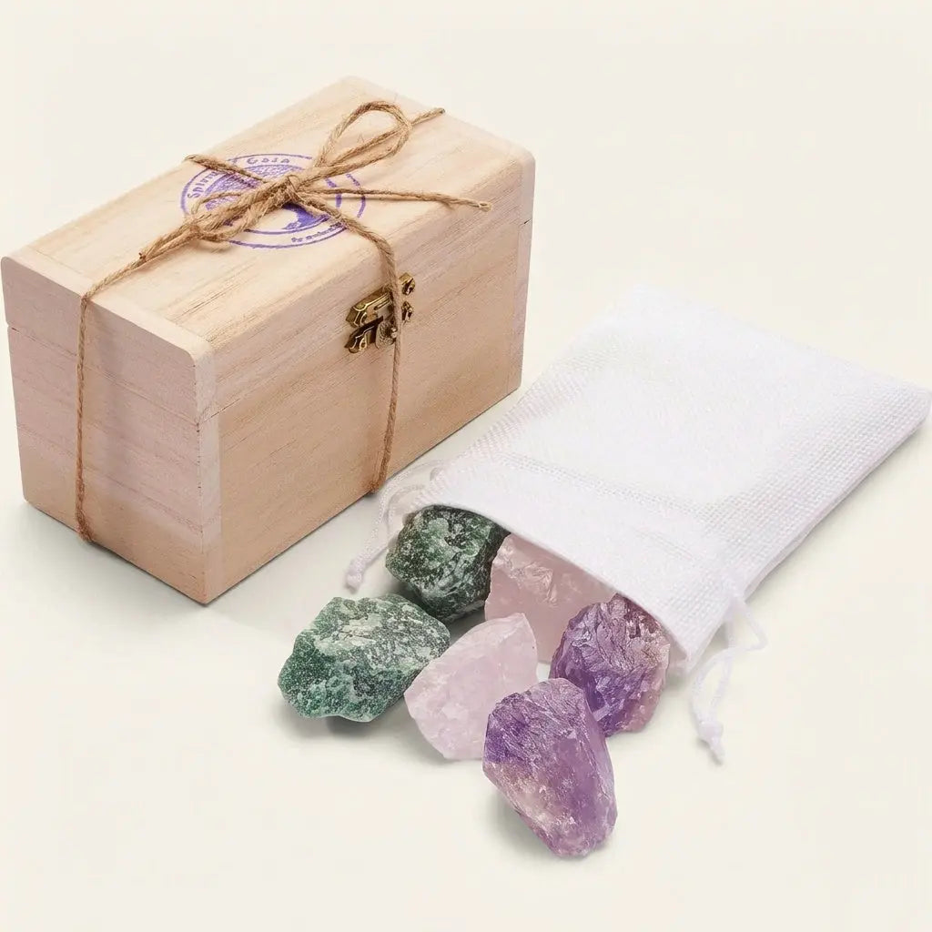 Wassersteine Entspannung – Holzkästchen mit weißem Jutesäckchen und Rohsteinen Amethyst, Rosenquarz und Aventurin vor hellem Hintergrund – Spirit of Gaia